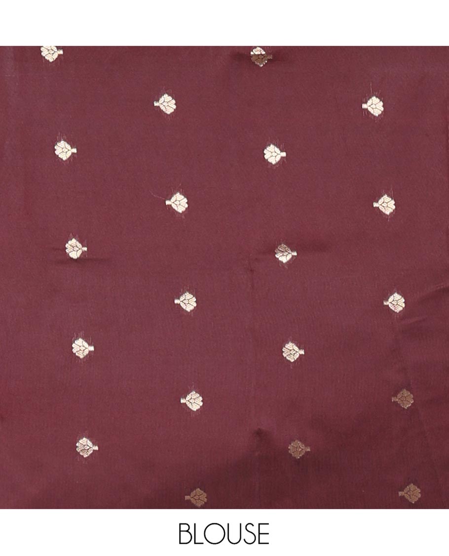 Maroon Plain Semi-Soft Silk Saree, Highlighted by Traditional Zari Designs Woven Border, Grandly Woven Pallu Steeped with Chakram Designs, and Paired with a Matching Blouse
