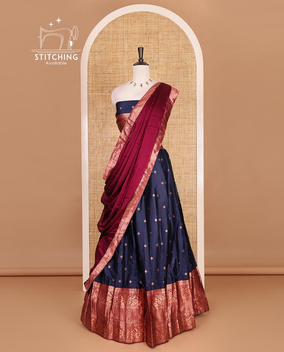 Navy blue taffeta silk half saree, zari buttas with contrast magenta traditional zari border skirt, matching zari design blouse, and contrast plain zari border syska georgette dhavani