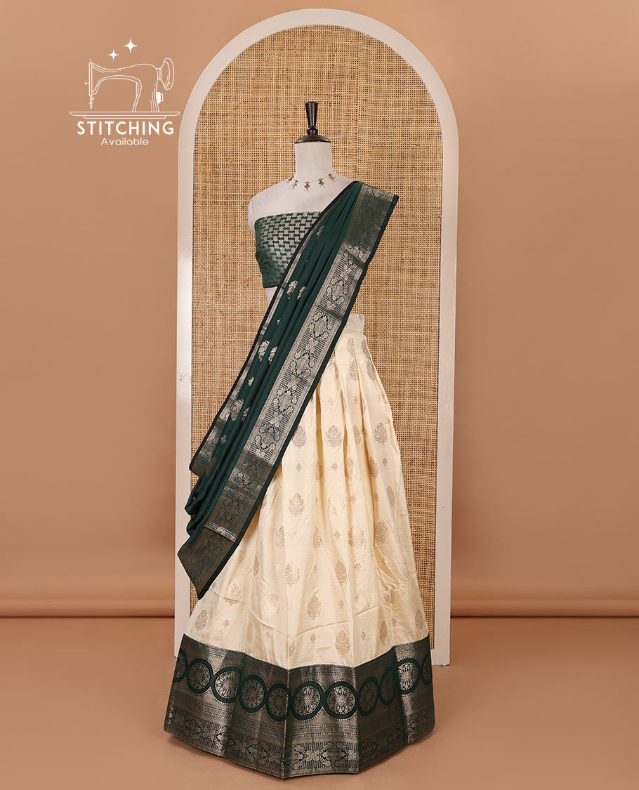 Cream-bottle green semi-banaras half-saree, zari buttas & contrast traditional zari border skirt, jacquard blouse & intricately zari woven dhavani
