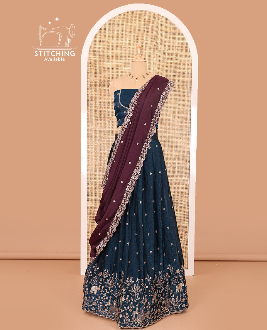 Peacock blue half-saree, buttas and flora-fauna embroidered bordered velvet organza skirt, a matching velvet organza blouse, and a contrast embroidered scallop syska georgette dhavanif