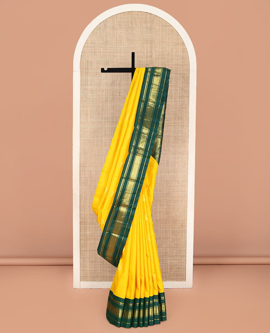 Yellow Kanchipuram Silk Saree, Adorned with Manga and Mayil Buttas, Complemented by Contrast One-Sided Korvai Border of Thilakam Mokku, Banaras, and Kuyil Kann Designs, Pallu Steeped with Mayil Designs, and Comes Without a Blouse