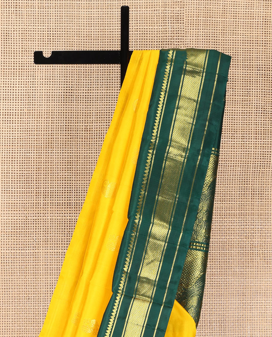 Yellow Kanchipuram Silk Saree, Adorned with Manga and Mayil Buttas, Complemented by Contrast One-Sided Korvai Border of Thilakam Mokku, Banaras, and Kuyil Kann Designs, Pallu Steeped with Mayil Designs, and Comes Without a Blouse