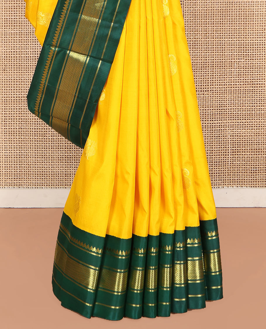 Yellow Kanchipuram Silk Saree, Adorned with Manga and Mayil Buttas, Complemented by Contrast One-Sided Korvai Border of Thilakam Mokku, Banaras, and Kuyil Kann Designs, Pallu Steeped with Mayil Designs, and Comes Without a Blouse
