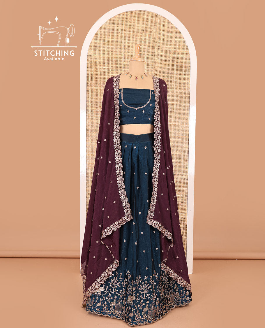 Peacock blue half-saree, buttas and flora-fauna embroidered bordered velvet organza skirt, a matching velvet organza blouse, and a contrast embroidered scallop syska georgette dhavanif