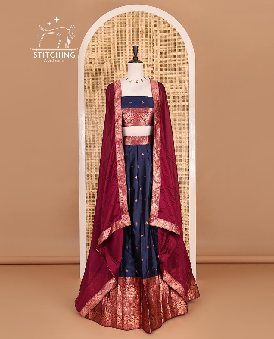 Navy blue taffeta silk half saree, zari buttas with contrast magenta traditional zari border skirt, matching zari design blouse, and contrast plain zari border syska georgette dhavani