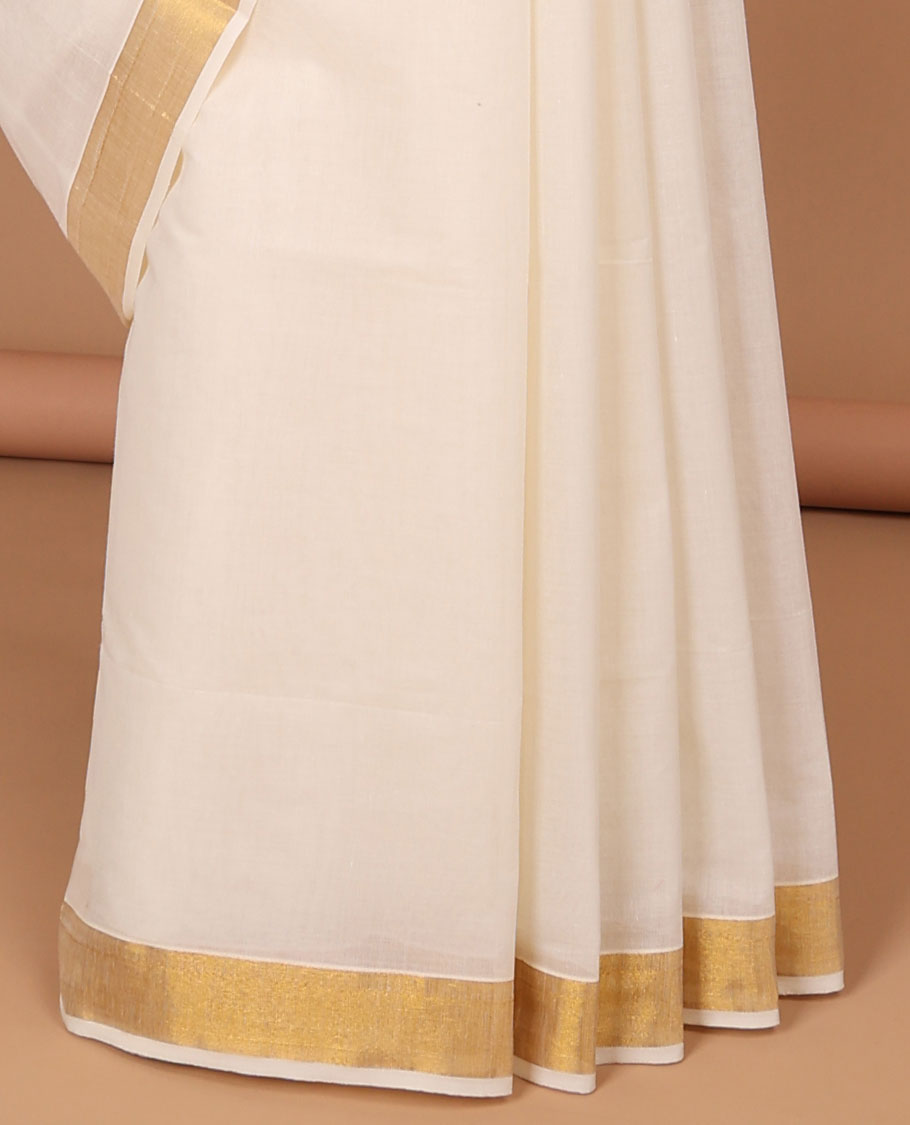 Cream kerala saree with zari stripes, zari border & pallu of intricate designs in zari