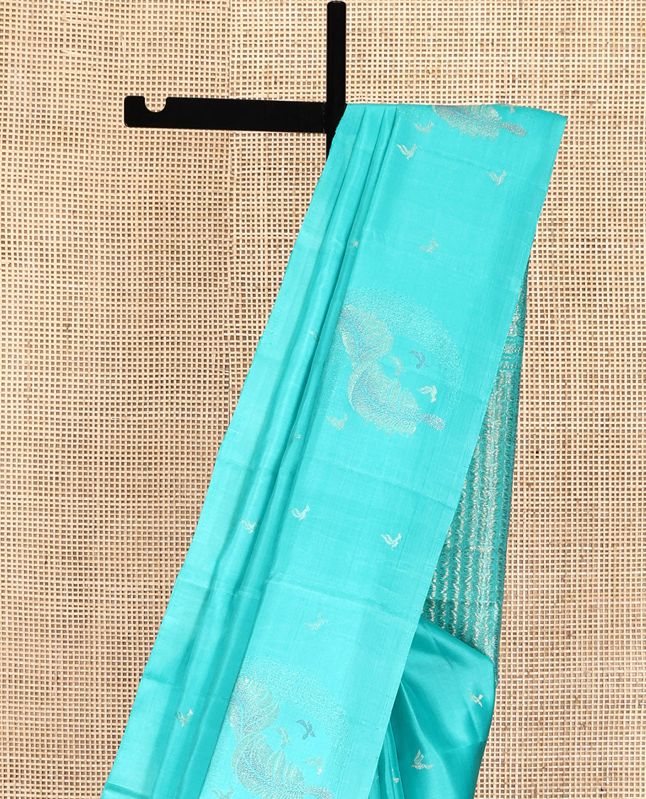 Borderless Blue Mayuri Soft Silk Saree, Subtly Woven with Buttas All Over Its Body, Highlighted by Pallu of Sparsely Woven Designs, and Paired with a Matching Blouse