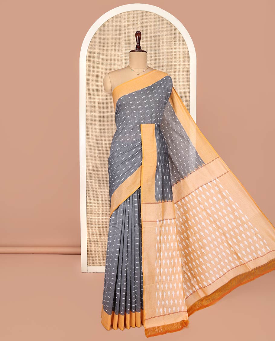Grey Ikkat Cotton Saree, Decked Up with Ikkat-Style Buttas on Its Body, Complemented by Contrast Border, Pallu Steeped with Ikkat Buttas, and Has No Blouse