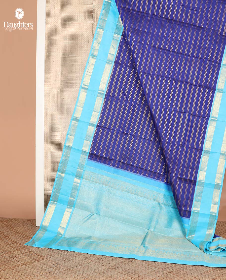 Blue zari striped Kanchipuram silksaree, contrast rettai pettu border of traditional zari designs, and zari-rich jaal pallu