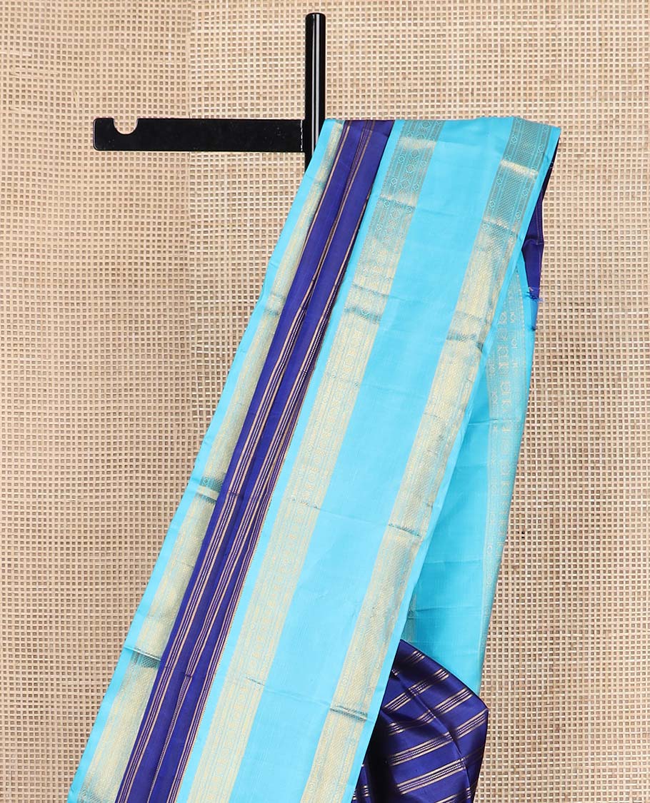 Blue zari striped Kanchipuram silksaree, contrast rettai pettu border of traditional zari designs, and zari-rich jaal pallu