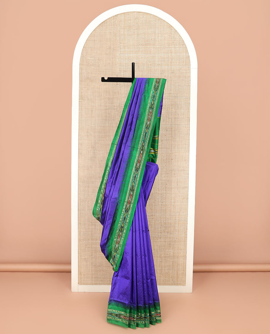 Violet Plain Ikkat Silk Saree with a Contrast Green Border Adorned by a Hazy Ikkat Weave, Featuring a Pallu Flanked by Stripes and Ikkat Texture