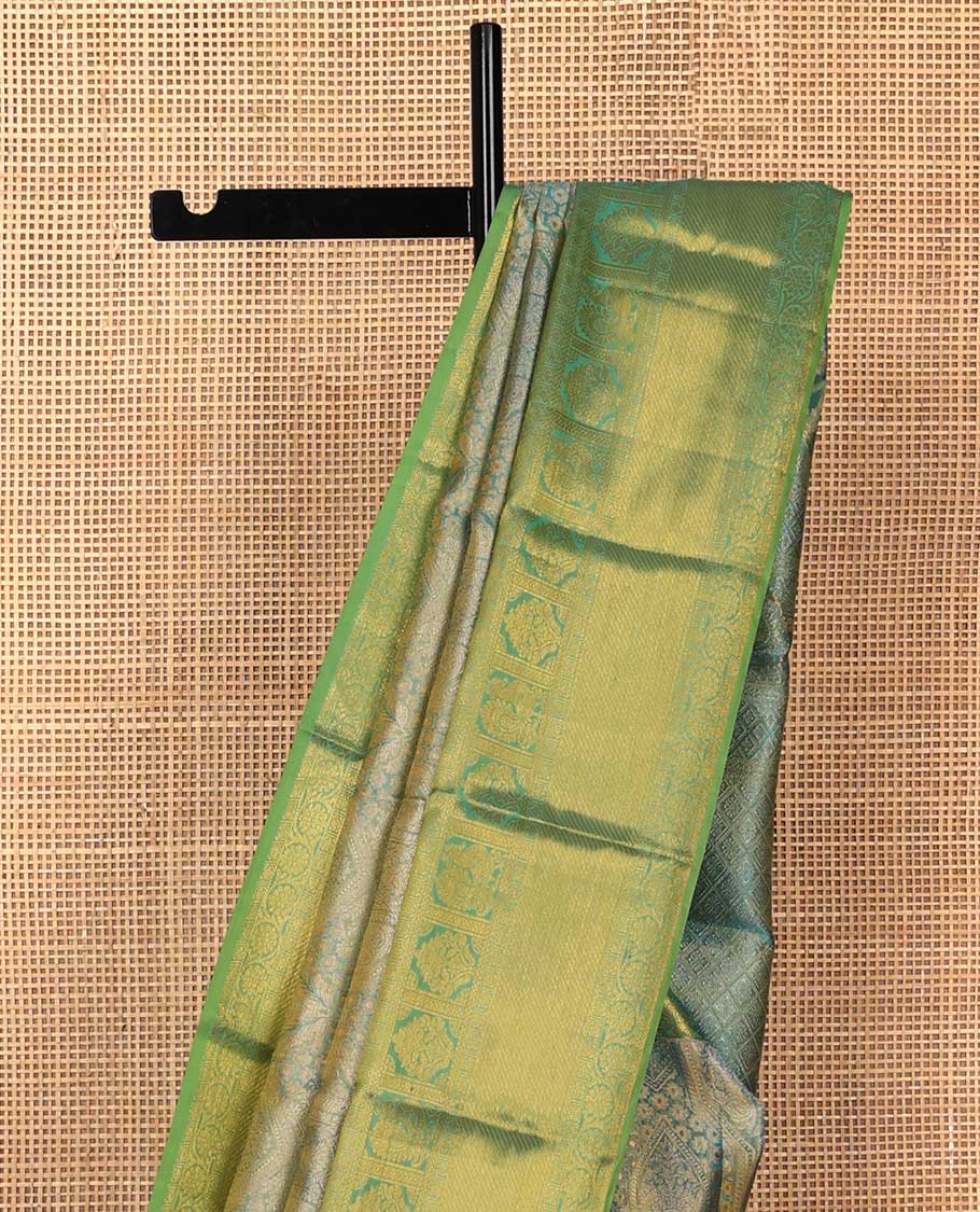 Blue jacquard Kanchipuram silk saree, contrast border of thilakam mokku, mayil, diamond, kodi visiry, and zari stripes, and zari-rich jaal pallu