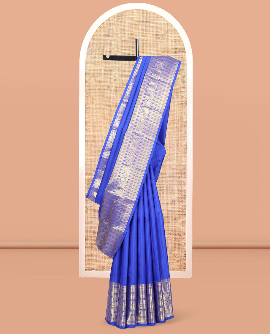 Blue Kanchipuram Silk Saree, Graced with Zari Buttas, Highlighted by Zari Border of Rekku, Vanki, Round Manga, and Round Mayil, Zari Design Pallu, and Matching Blouse