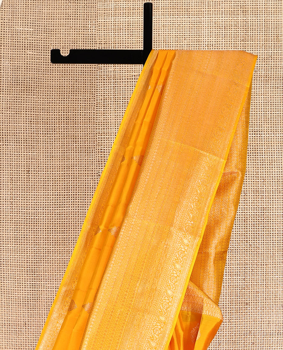 Yellow Kanchipuram Silk Saree, Subtly Sparkled with Zari Buttas All Over Its Body, Highlighted by a Zari Traditional Design Border, Grand Pallu, and Paired with a Matching Blouse