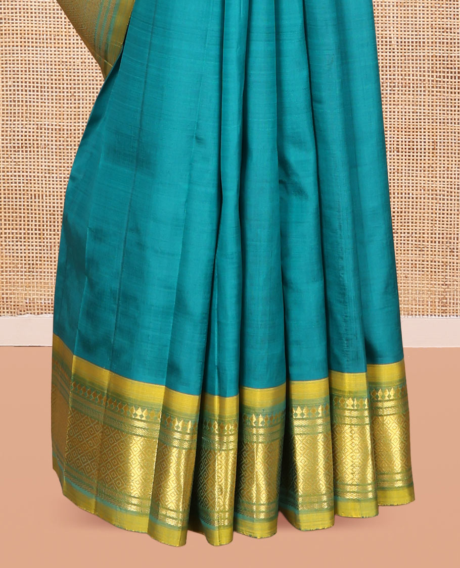 Green Kanchipuram Silk Saree, Adorned with Zari Buttas, Complemented by a Contrast One-Sided Border of Panner Sombu, Banaras, and Mayil Kann Designs, Zari Woven Pallu, and a No Blouse