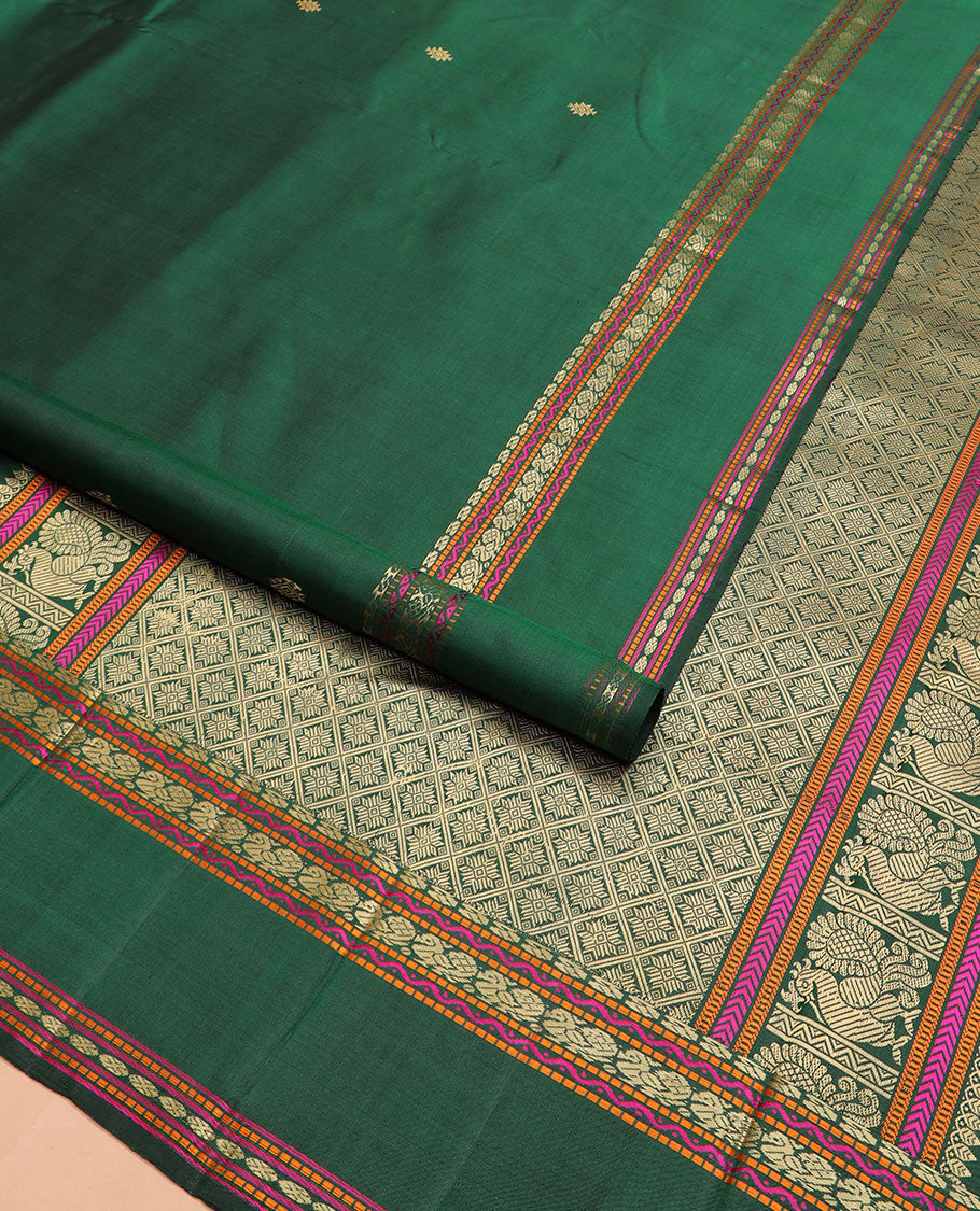Green buttas Kanchipuram silk saree, rettai pettu border of manga, neli, mayil, and rudraksham designs, and jaal pallu