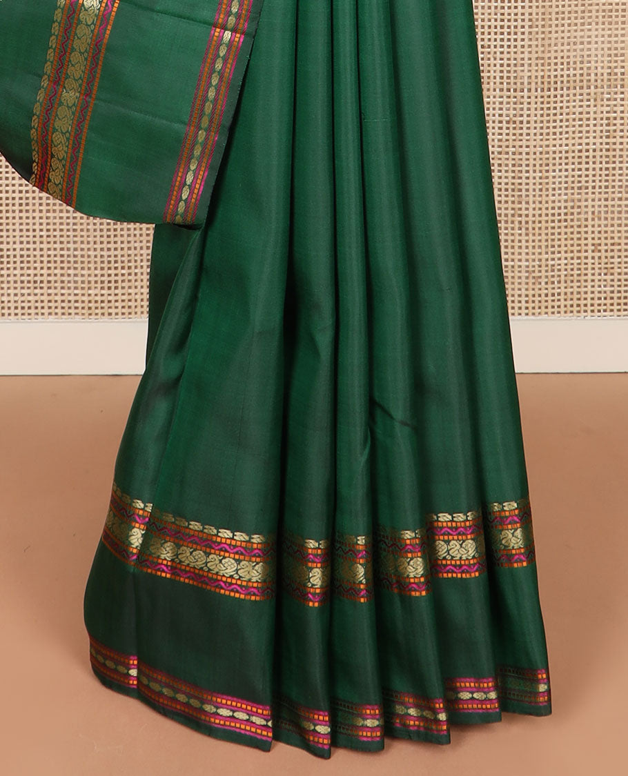 Green buttas Kanchipuram silk saree, rettai pettu border of manga, neli, mayil, and rudraksham designs, and jaal pallu