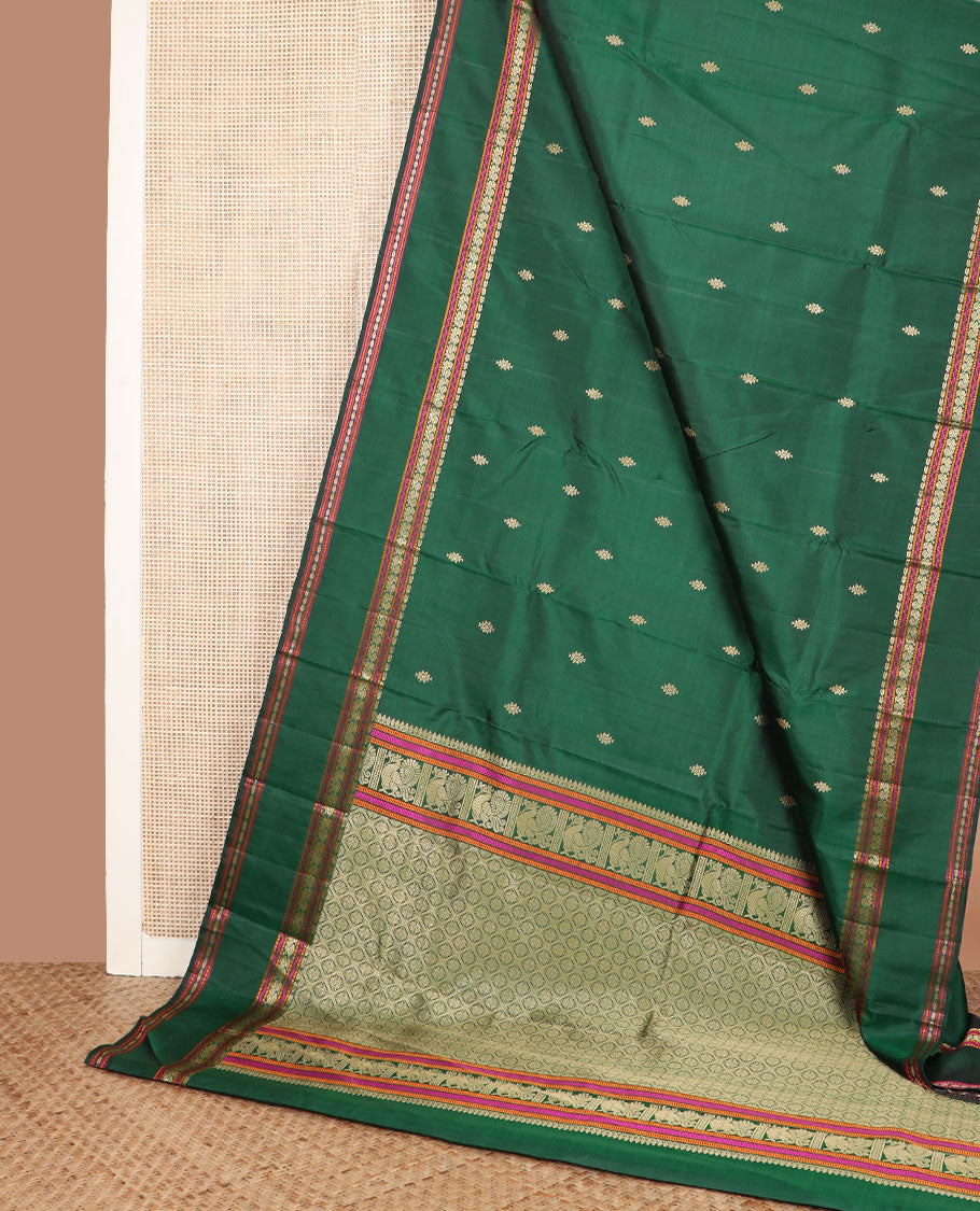 Green buttas Kanchipuram silk saree, rettai pettu border of manga, neli, mayil, and rudraksham designs, and jaal pallu