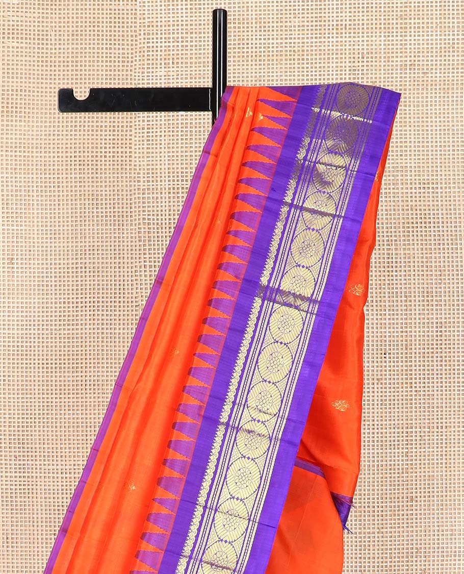 Orange zari buttas Kanchipuram silk saree, contrast one-sided thazampoo rekku border of salangai, banaras, muthu, and poo chakram designs, and zari design pallu