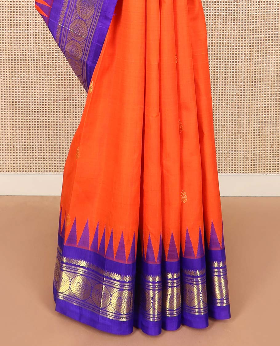 Orange zari buttas Kanchipuram silk saree, contrast one-sided thazampoo rekku border of salangai, banaras, muthu, and poo chakram designs, and zari design pallu
