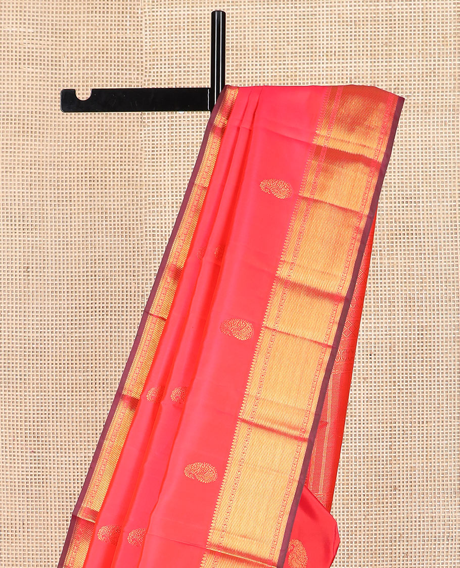 Red manga buttas Kanchipuram silk saree, zari border of thilakam mokku, zari stripes, and manga designs, and geometric patterned pallu