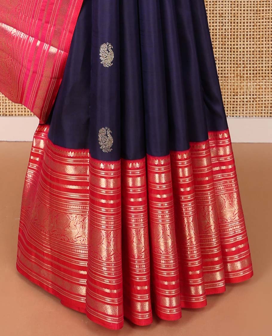 Dark blue buttas kancheepuram silk saree with contrast ganga jamuna, korvai border of thilakam mokku, muthu, banaras, mayil, manga design & zari design pallu