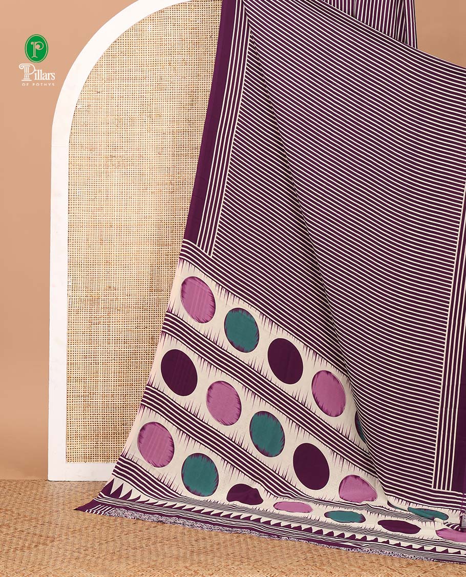 Purple vertical stripes printed modal satin saree, a self-border of horizontal stripes print, polka dots printed on the pallu, and an intricate ajrakh-style printed blouse