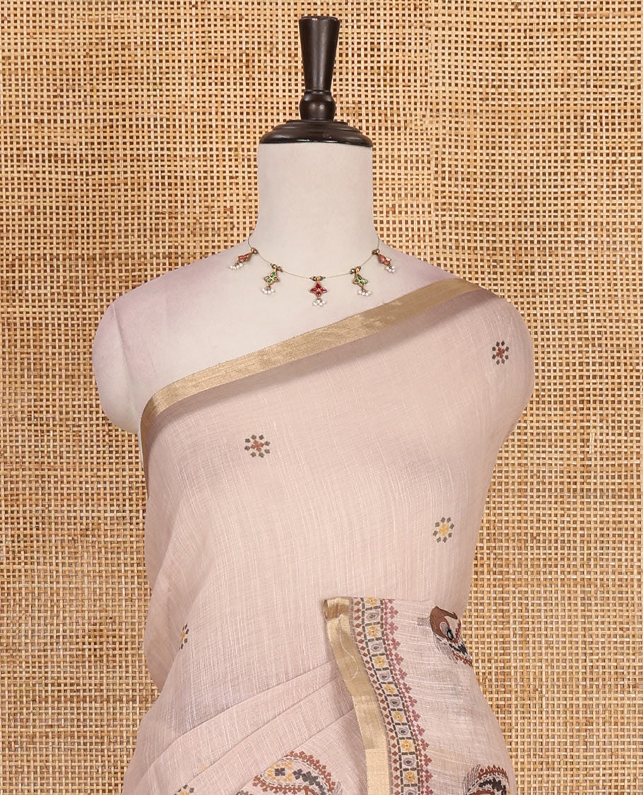 Chikku buttas with mirror work linen saree, zari border with peacock motifs print, printed mirror work pallu, and matching blouse