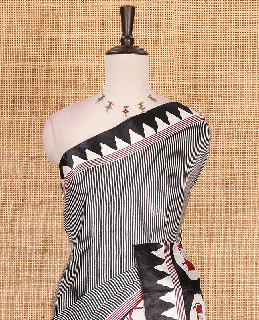 Cream-black vertically striped khadi cotton saree, contrast Pichwai cow printed temple border, Pichwai cow print pallu, and jaal printed blouse