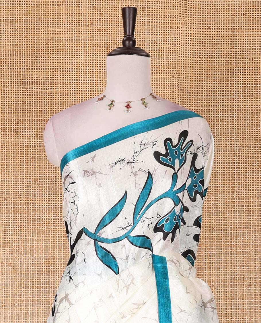 Half-white batik-style floral vine printed khadi cotton saree, contrast rama blue border, batik floral printed, and contrast flower motifs printed blouse