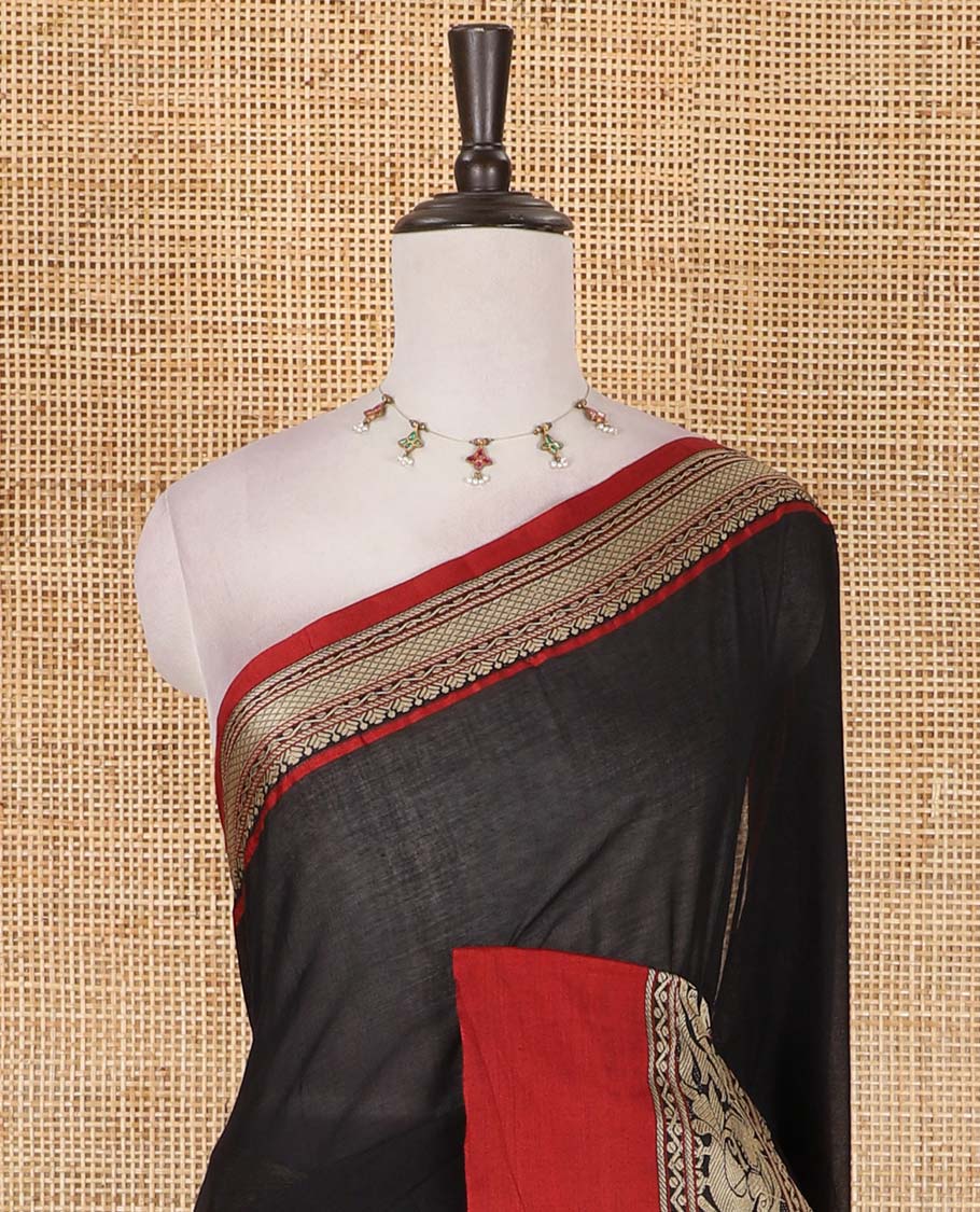 Black plain mercerised cotton saree, contrast traditional border of peacock, and elephant motifs, striped pallu, and a matching blouse