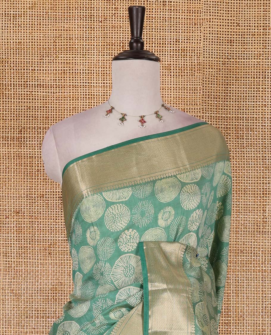 Green uniquely printed semi-tussar saree, traditional zari border, zari striped pallu, and a matching blouse