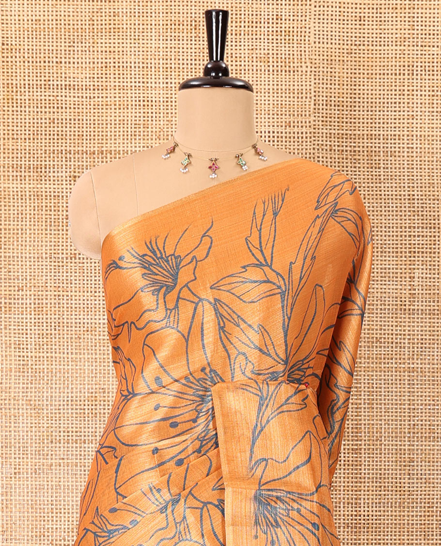 Borderless orange big floral motifs printed tissue silk saree with floral printed pallu, and a contrast plain blouse
