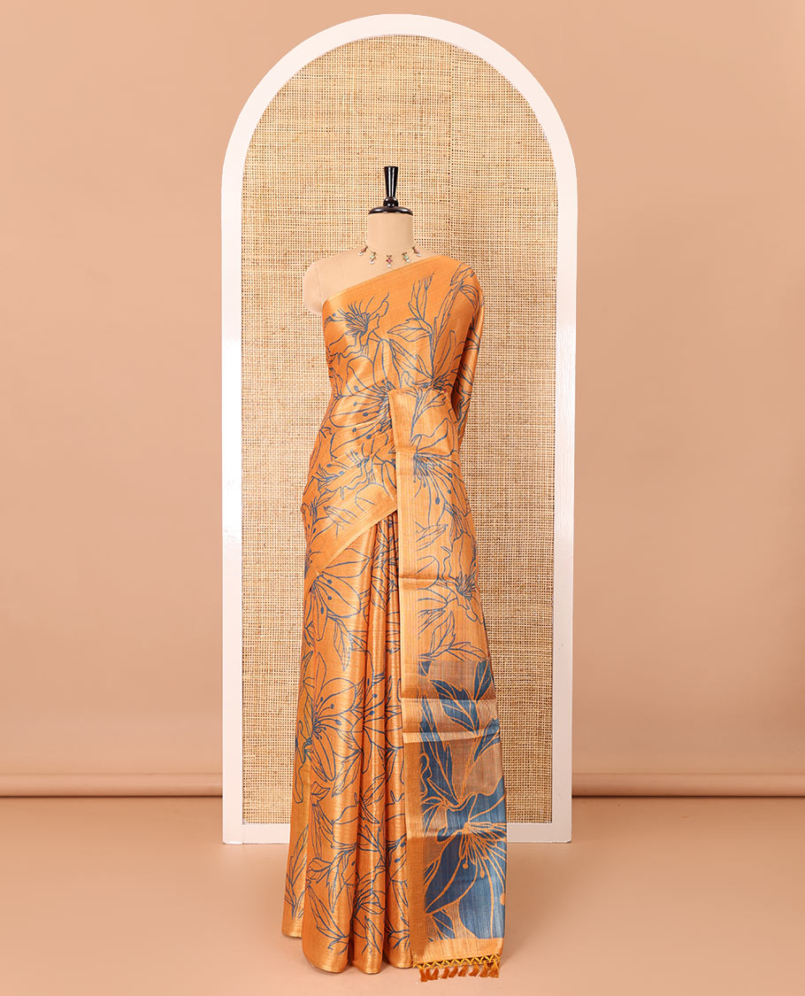Borderless orange big floral motifs printed tissue silk saree with floral printed pallu, and a contrast plain blouse