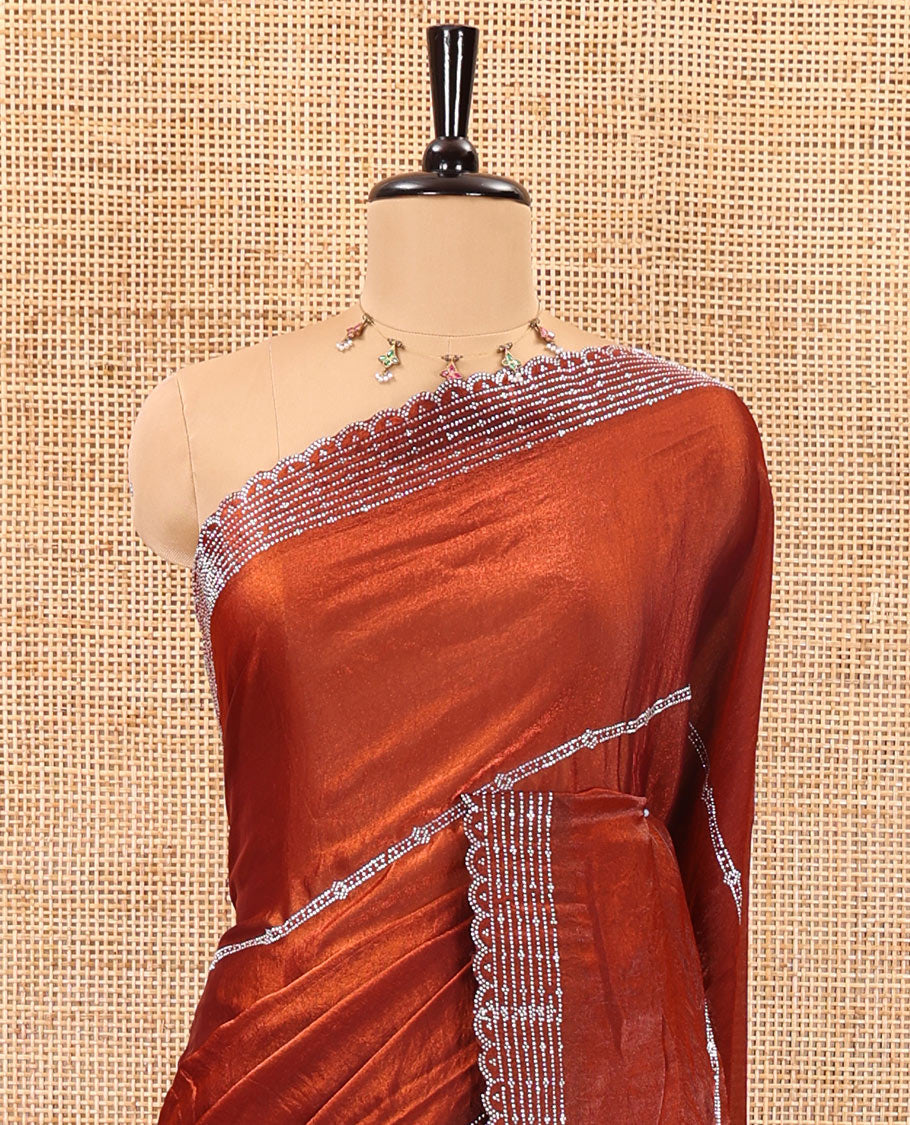 Rust color horizontally swarovski stone striped fendi chiffon saree, swarovski stone work border, and a plain blouse
