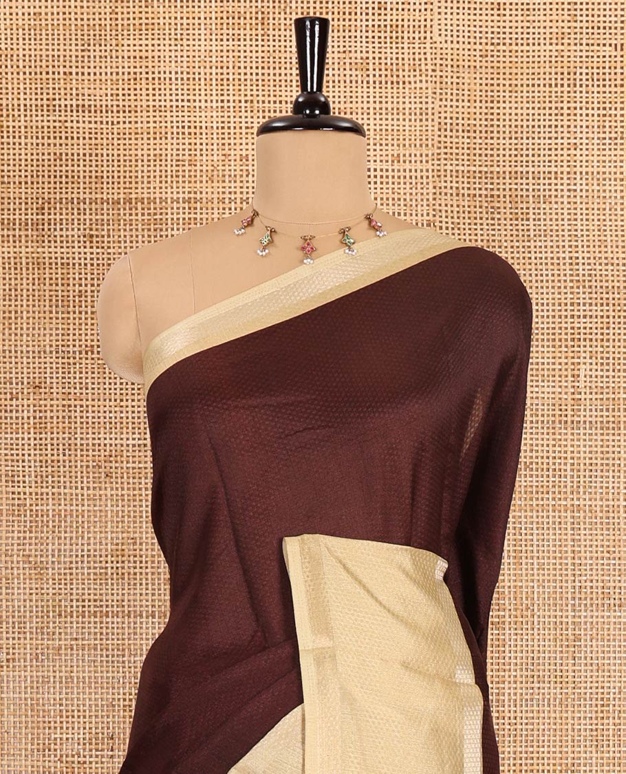 Brown embossed moss chiffon saree, contrast traditional rettai pettu border, embossed pallu, and a contrast embossed blouse