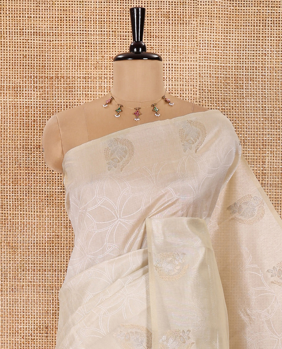 Cream Semi Tussar Saree Detailed with Jaal Design, Subtle Border of Zari Motifs, Delicately Woven Pallu of Intricate Designs, and Paired with a Matching Blouse