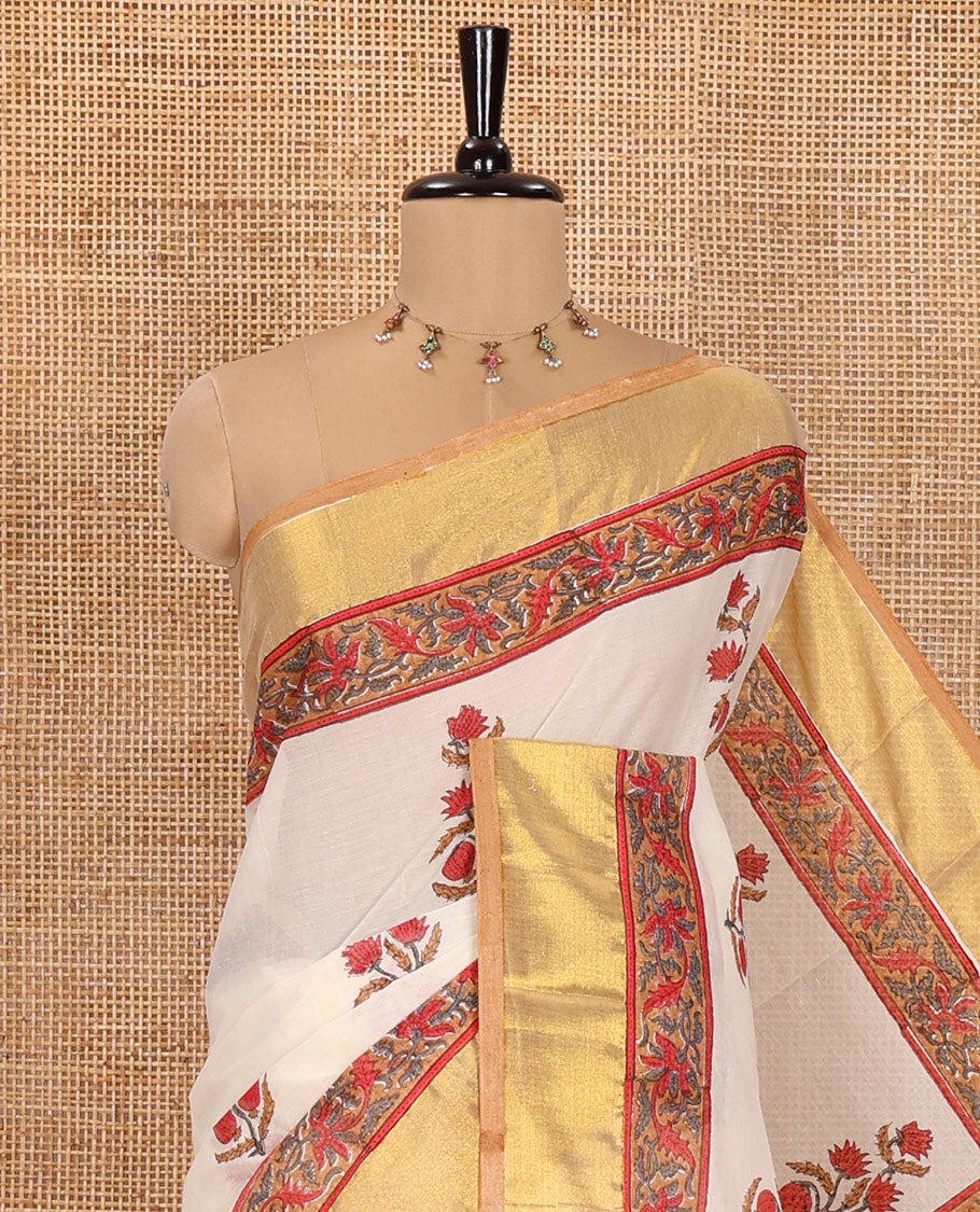 Cream Kerala Cotton Saree, Elevated with Floral Buttas Printed on Its Body, Highlighted by Gleaming Golden Zari Border, Pallu Features the Floral-Paisley Print, and Paired with a Matching Printed Blouse
