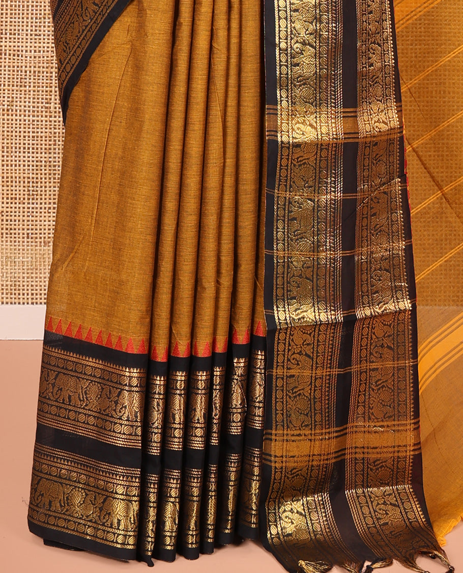 Mustard Plain Chettinad Cotton Saree, Complemented by a Contrast Rettai Pettu Red-Thread-Temple Border of Coin, Elephant, and Peacock Designs, Subtly Striped Pallu, and Paired with a Matching Blouse