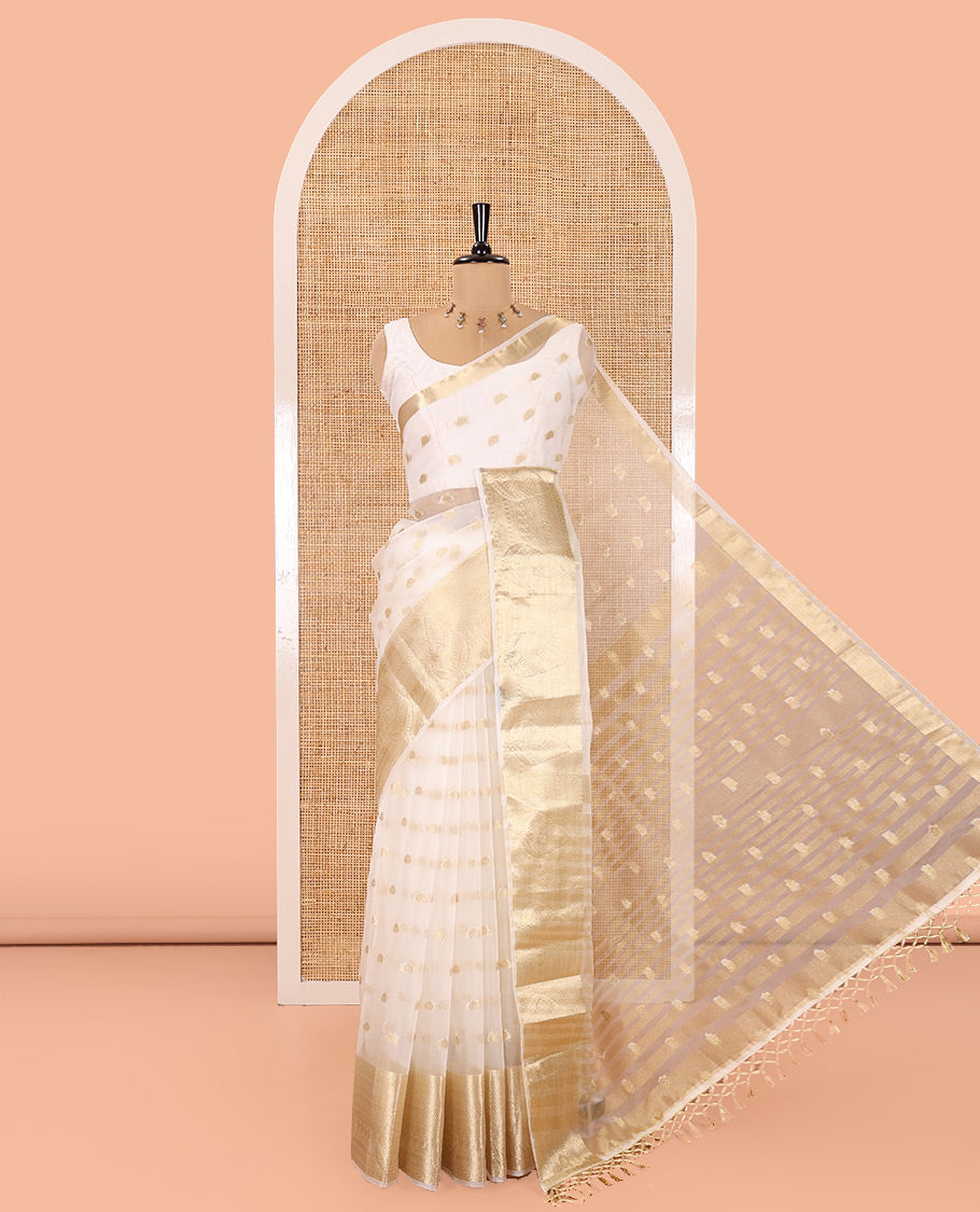 Cream Semi-Organza Saree, Shimmering with Zari Buttas All Over Its Body, Highlighted by a Traditional Zari Design Border, Gleaming Zari Design Pallu, and Paired with a Matching Blouse