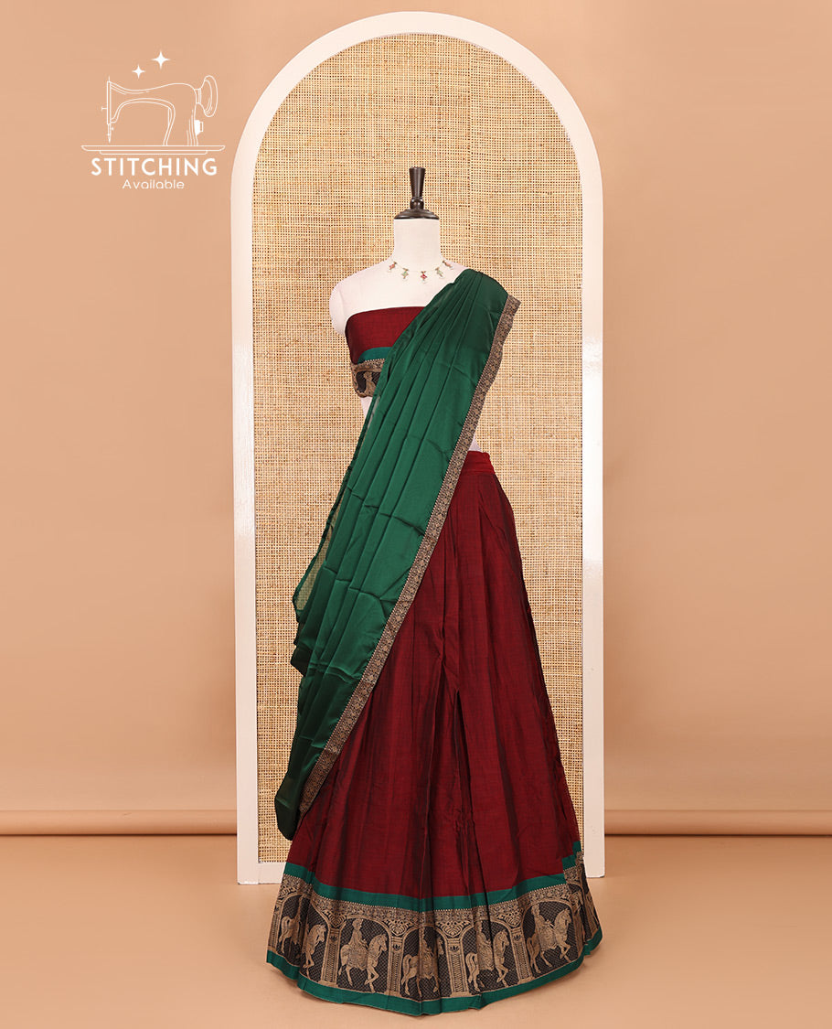 Maroon with green mercedised cotton half-saree, contrast elephant zari border skirt, matching blouse & one side border georgette dhavani