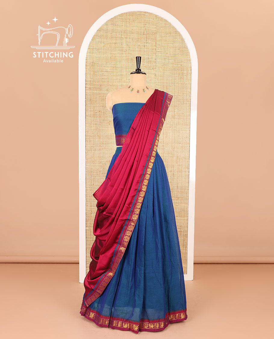 Blue half saree, plain with contrast zari peacock motifs bordered skirt, matching blouse and a contrast peacock border dhavani
