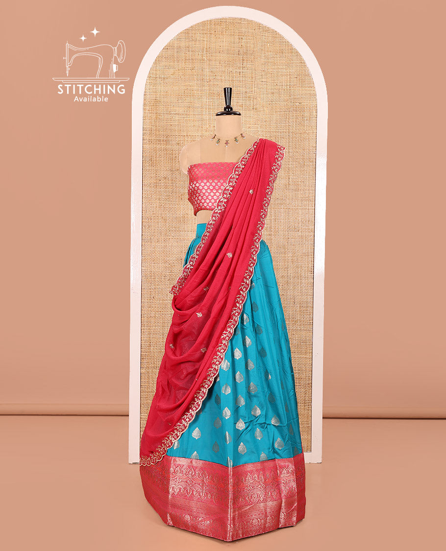 Blue and Rani Pink Semi-Banaras Silk Half-Saree Featuring Zari Buttas All Over the Skirt, Highlighted with a Contrast Traditional Zari Design Border, Rudraksham Motifs Woven Blouse, and a Shimmer Georgette Scallop-Embroidered Dhavani