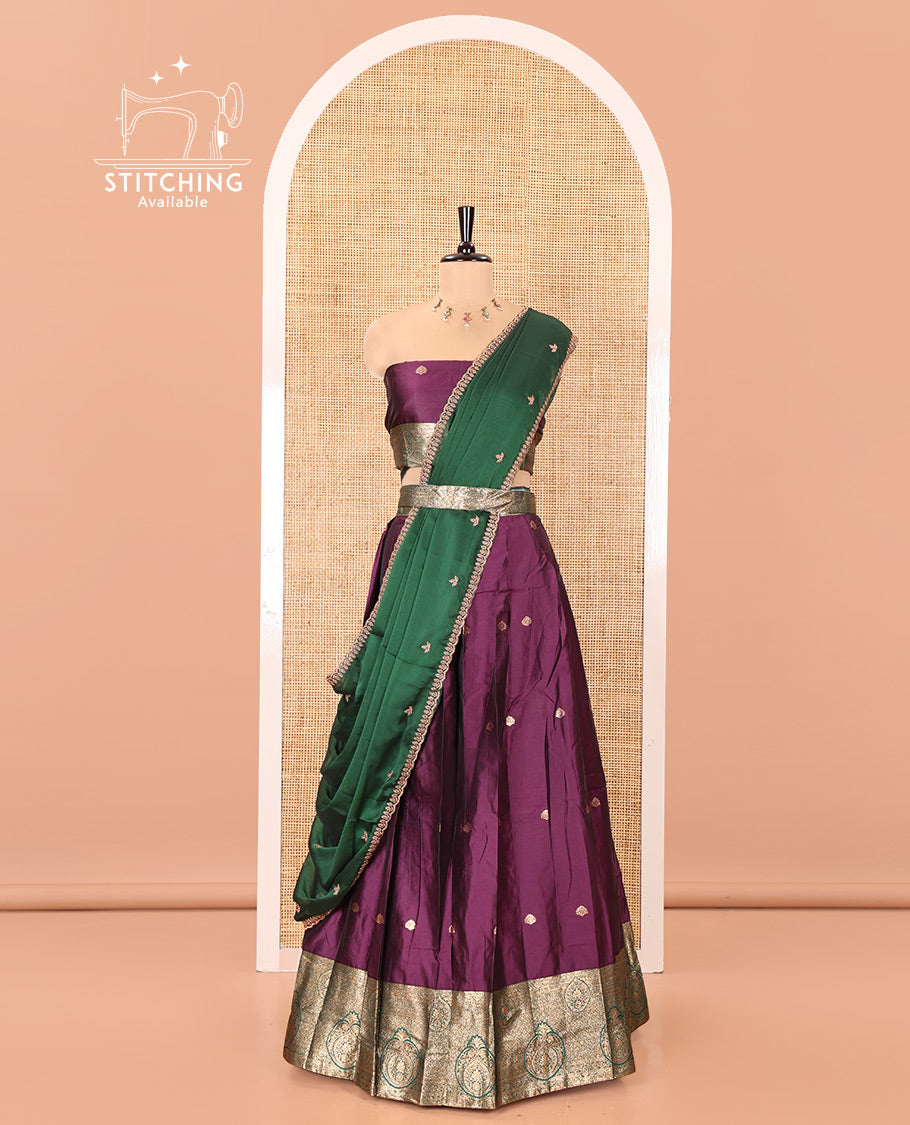 Purple and Green Semi-Banarasi Half-Saree, Entralled with Zari Buttas on Its Skirt, Complemented by a Contrast Intricately Zari-Designed Border, Paired with a Matching Blouse, and a Contrast Satin Georgette Embroidered Scallop Dhavani