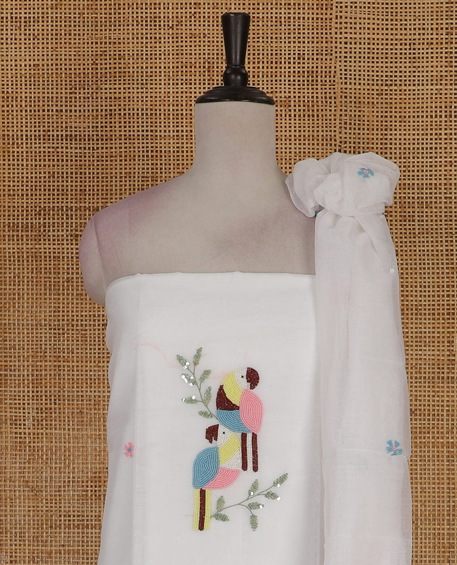 White net kota material chudidar set, macaw parrot, and flower motifs, multi-color sugar bead embroidered top, plain santoon bottom, and sugar bead embroidered dupatta