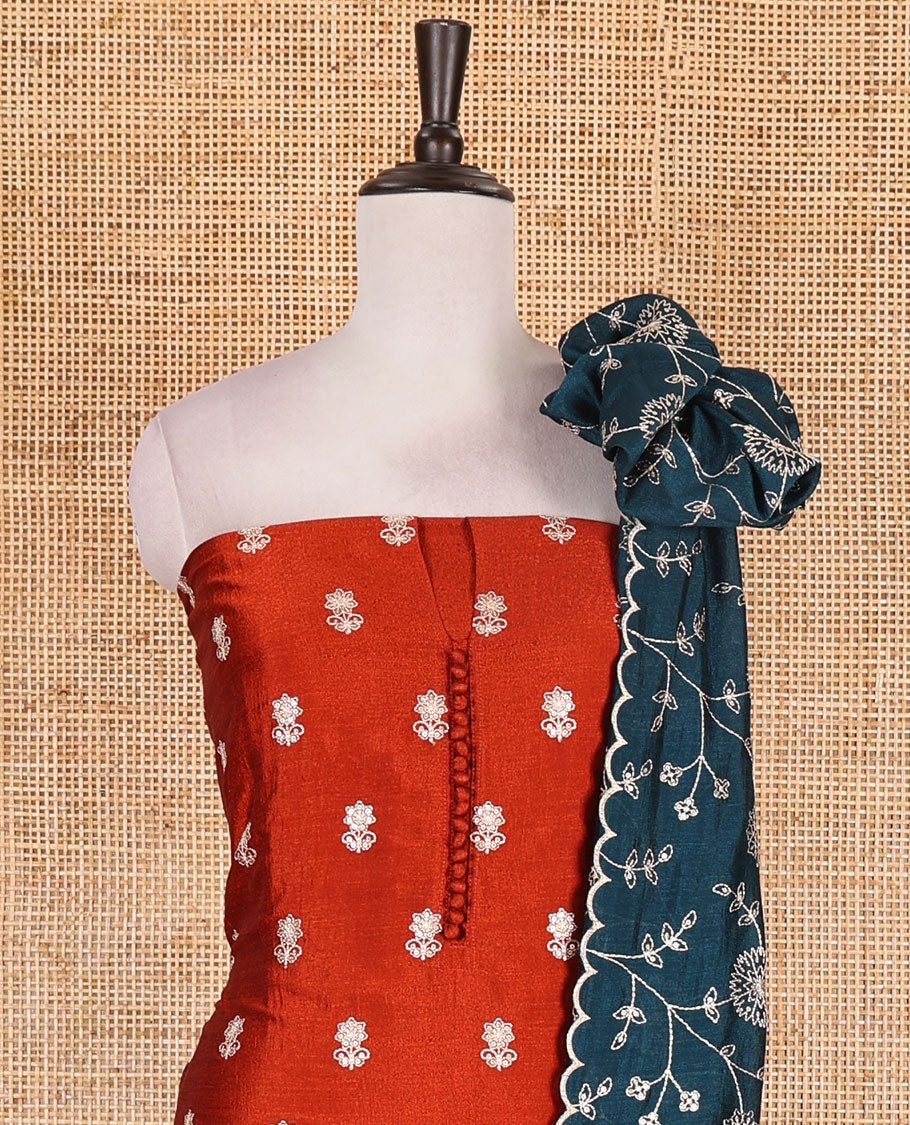 Rust Vichitra silk material churidar set, floral motifs embroidered top, contrast Santoon bottom, and floral vine thread embroidered scallop dupatta