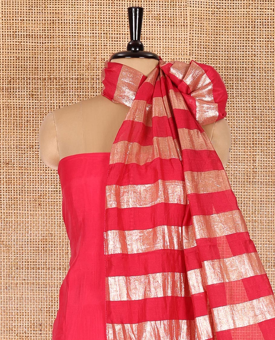 Pink material chudidar set, plain with pom-pom tasseled mul chanderi top, a matching bottom, and organza dupatta of stripes