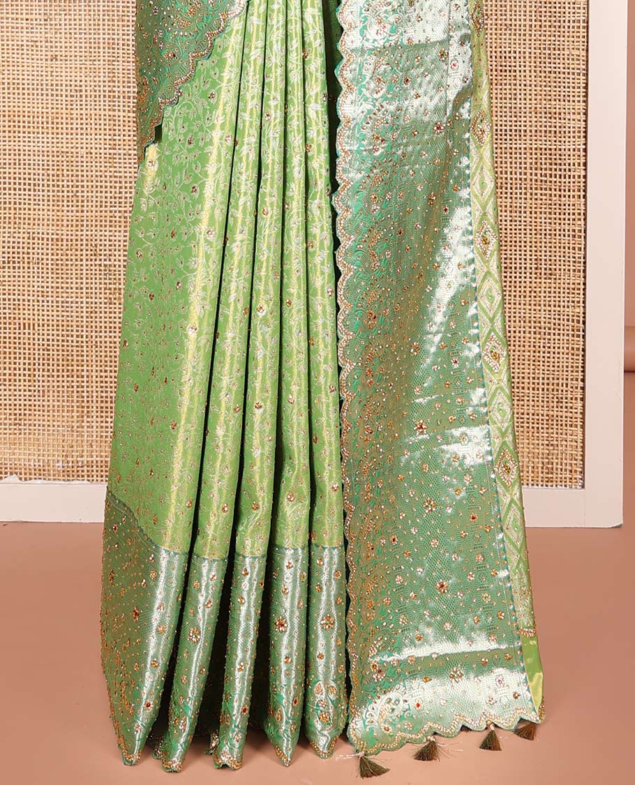 Green Vastrakala Silk Saree Highlighted with Floral Jacquard and Stone Work, Complemented by Contrast Traditional Zari and Stone Embroidered Scallop Border, Pallu Features Jaal Design and Stone Work, and Paired with Contrast Stone Embroidered Blouse
