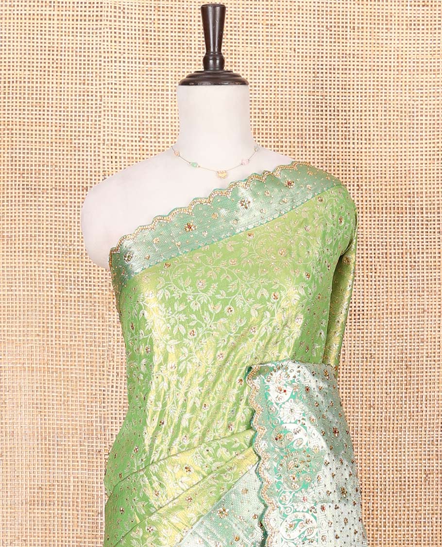 Green Vastrakala Silk Saree Highlighted with Floral Jacquard and Stone Work, Complemented by Contrast Traditional Zari and Stone Embroidered Scallop Border, Pallu Features Jaal Design and Stone Work, and Paired with Contrast Stone Embroidered Blouse