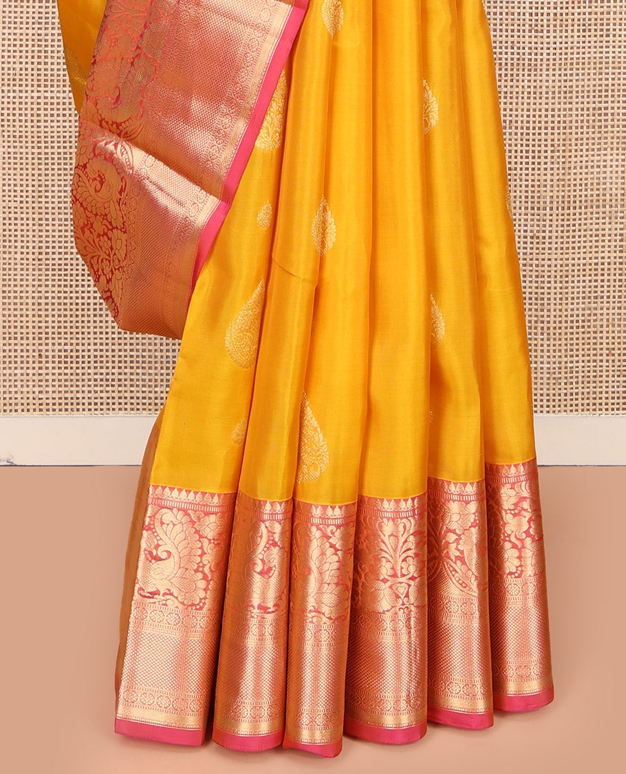 Yellow Vasundhara Lite Silk Mix Saree, Adorned with Zari Buttas All Over Its Body, Complemented by a Contrast Border of Thilakam Mokku, Muthu, Mayil, Kamalam, and Mayil Kann Designs, Gracefully Embellished Pallu, and Paired with a Contrast Blouse